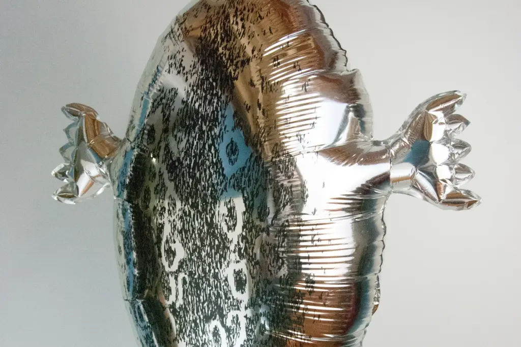 A silver foil balloon shaped like a sealskin hunting float