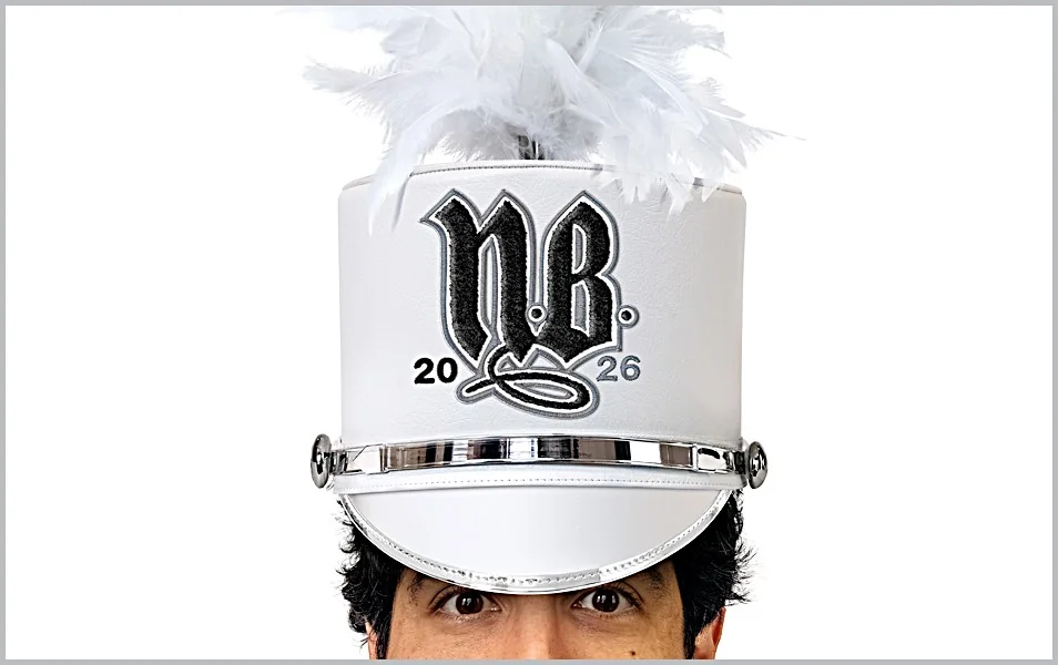 A performer wearing a white marching-band hat for the 2026 project preview