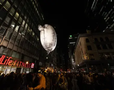 Avataq floating above a crowd on Yonge Street during Nuit Blanche 2022