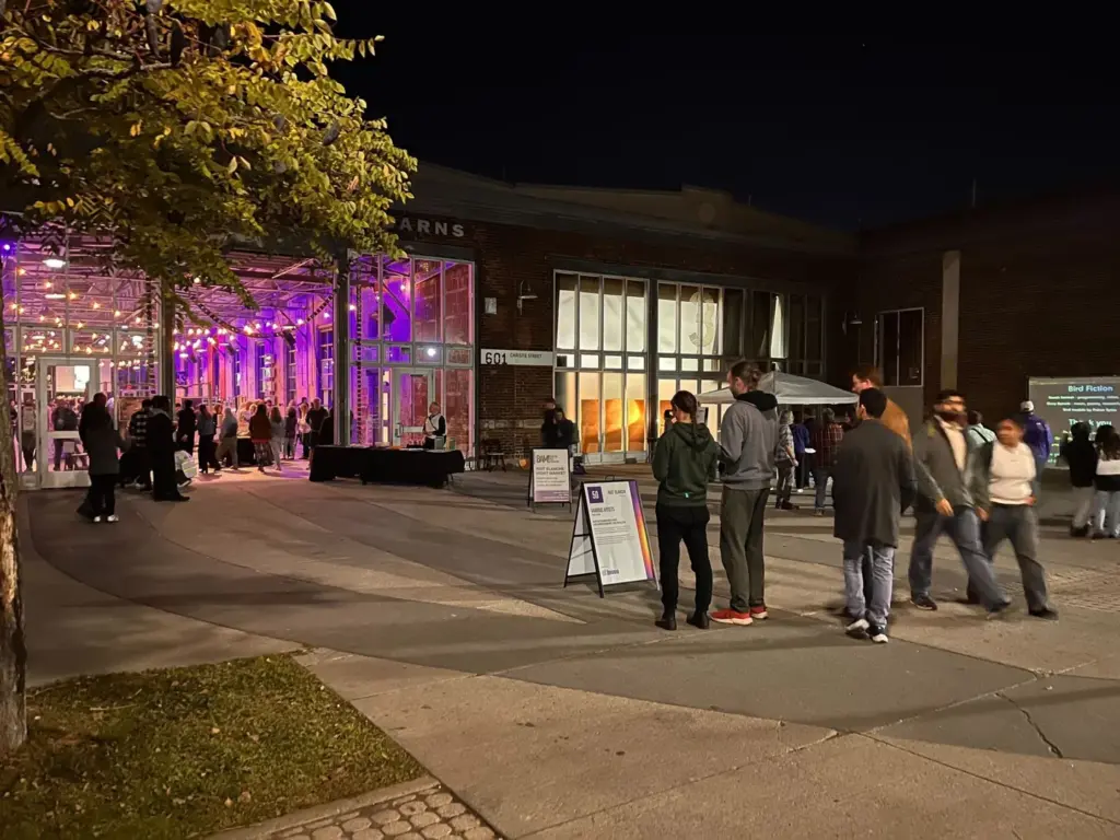 Visitors outside Wychwood Barns at night in 2024