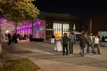 Visitors outside Wychwood Barns at night in 2024