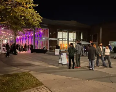 Visitors outside Wychwood Barns at night in 2024