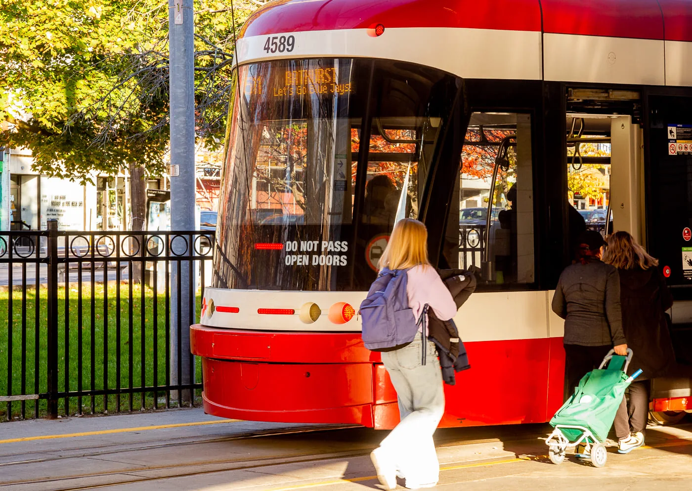 Passengers boarding a red and white TTC streetcar