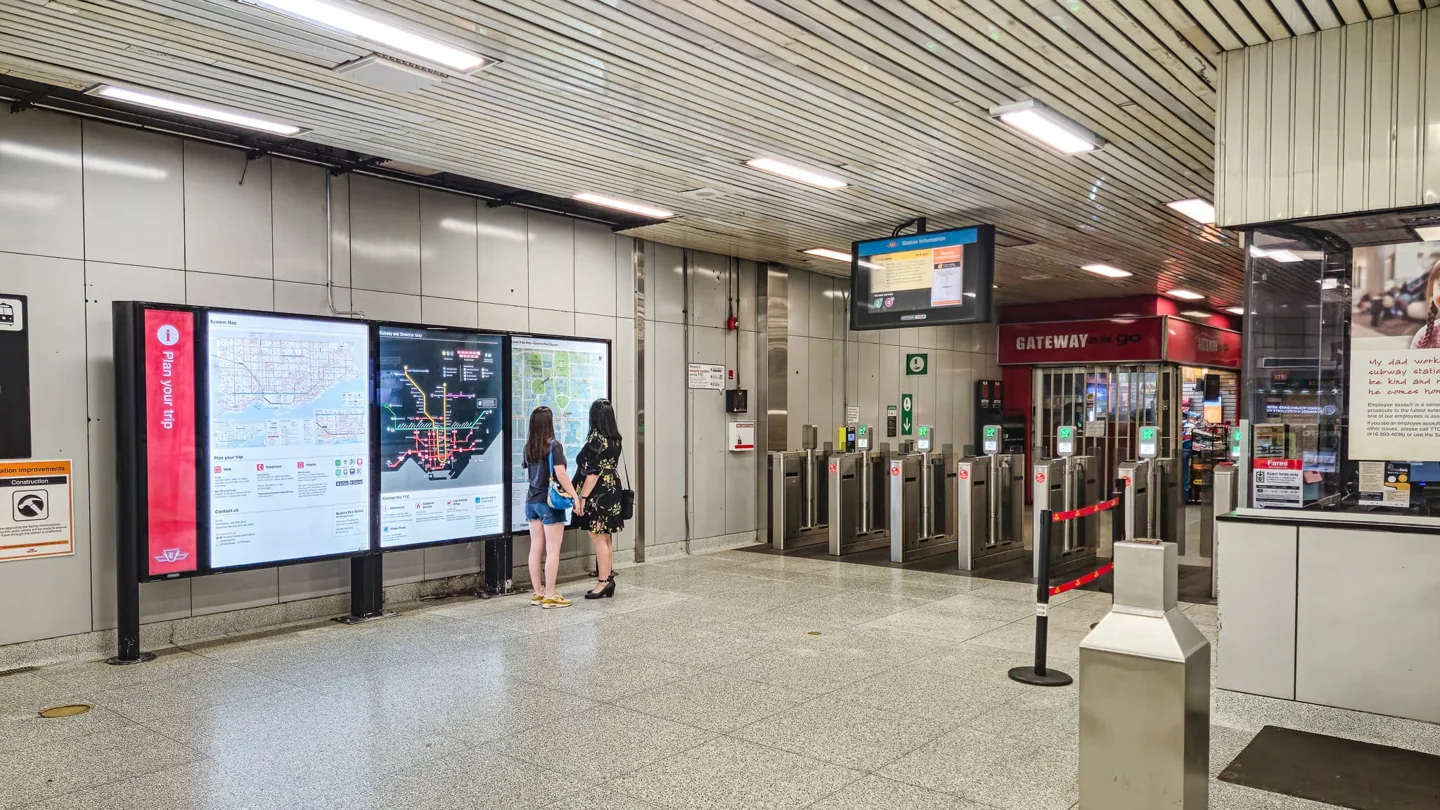 Passengers checking a map inside a TTC subway station.
