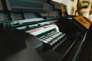 An industrial printing press with colour controls and printed output