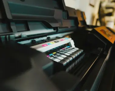 An industrial printing press with colour controls and printed output