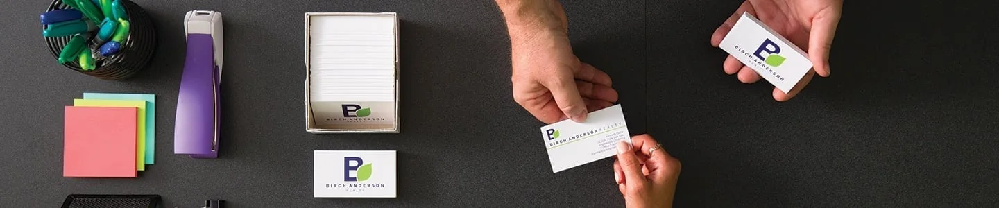 Printed cards and papers arranged on a desk