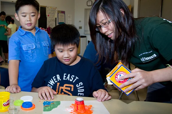 A City staff member is assisting a class with children.