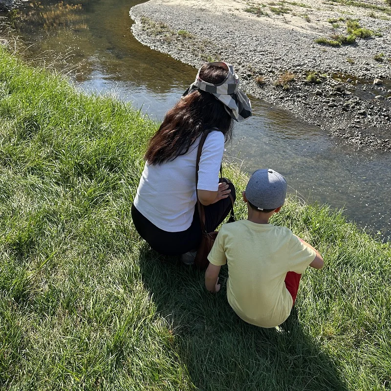 A parent and child watching Highland Creek at a TRCA salmon event