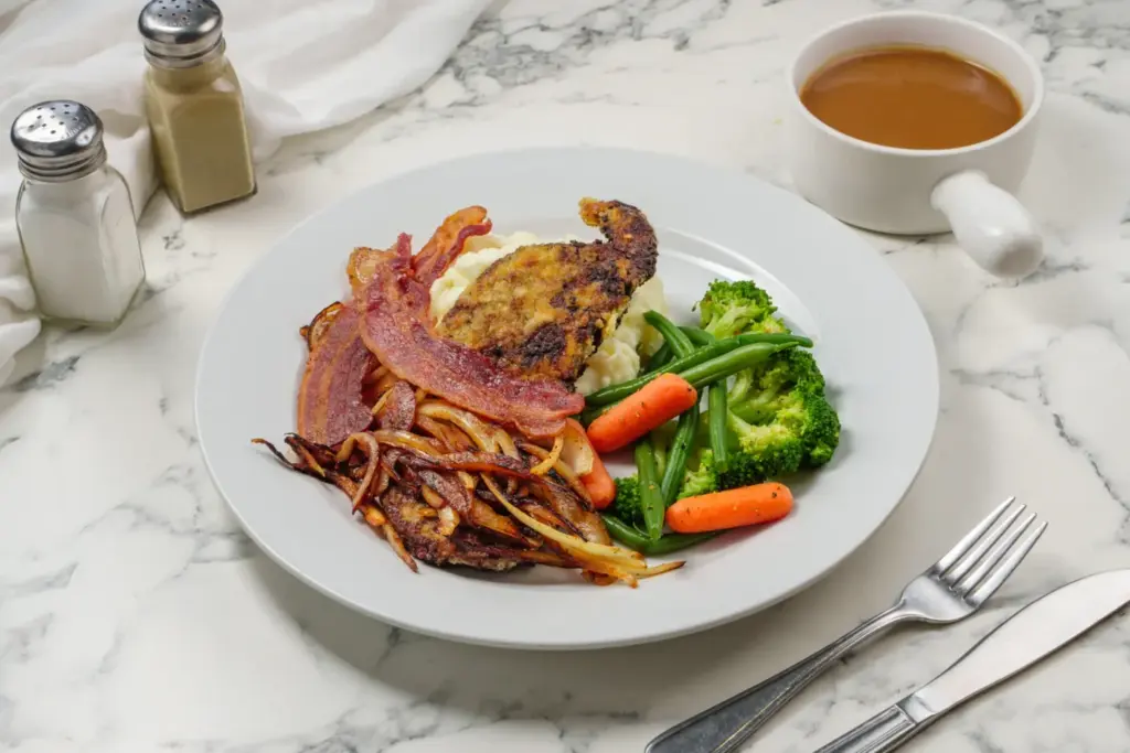 A regular meat main with vegetables and a gravy jug at Donlands Diner