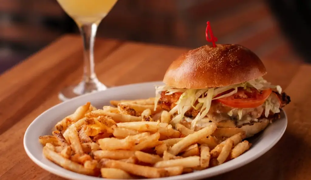 Burger and fries on a plate at Hemingways