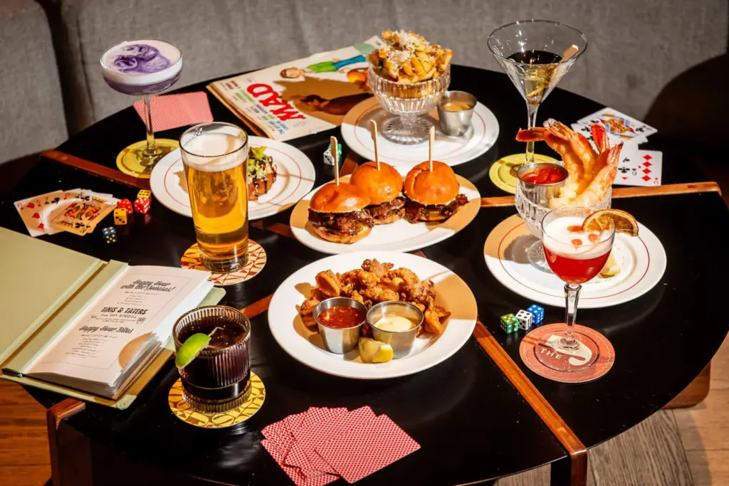 Drinks and several dishes on a table at The Joneses