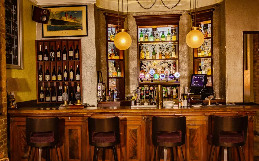 Wooden bar and stools at Queen and Beaver