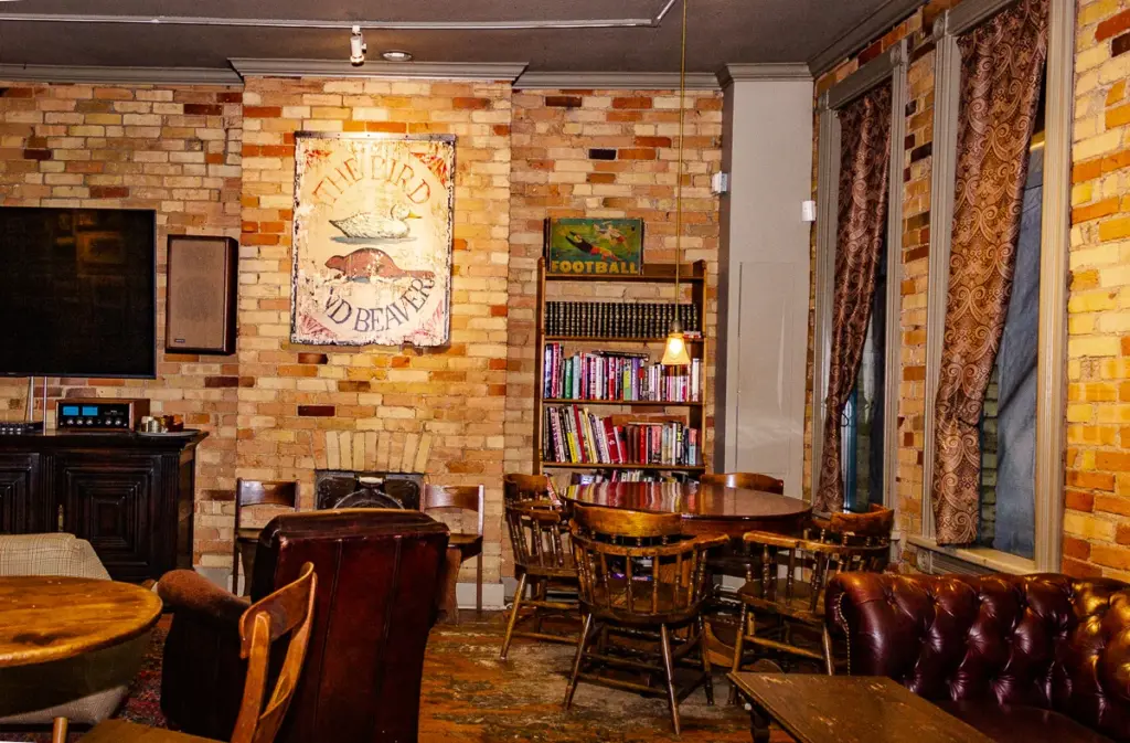 Brick walls and wooden chairs inside Queen and Beaver