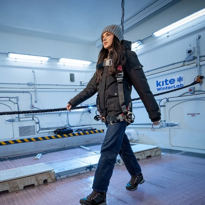 Woman in a safety harness walking across the WinterLab ice floor
