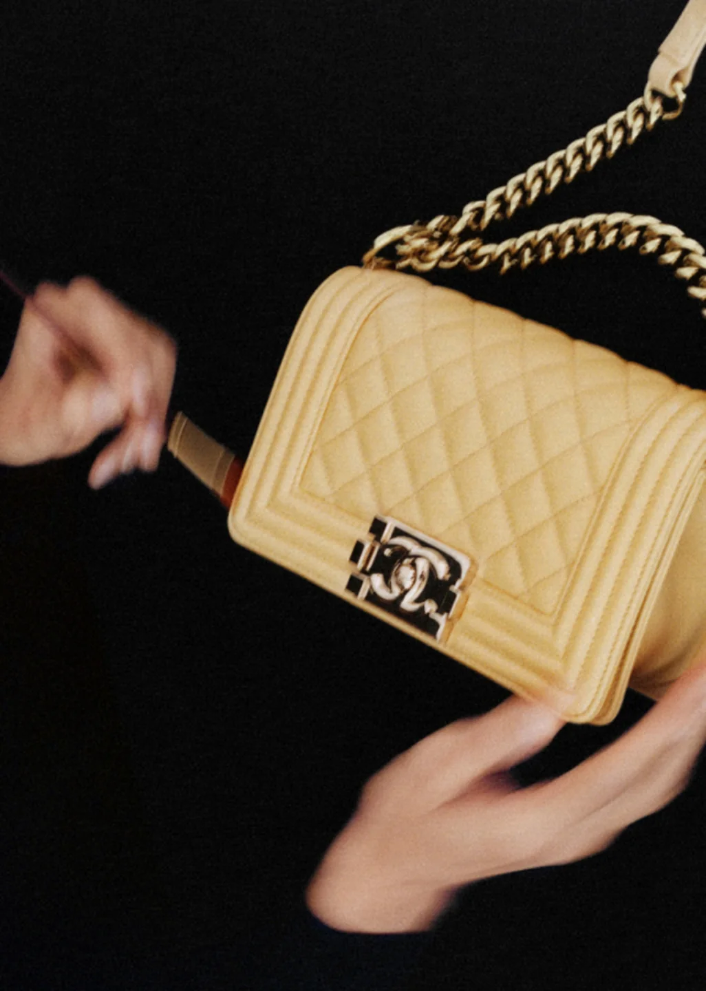 A light brown Chanel bag with a chain strap