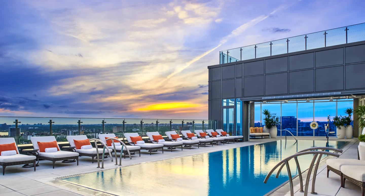 Hotel X Toronto’s rooftop pool with sunset light over the water
