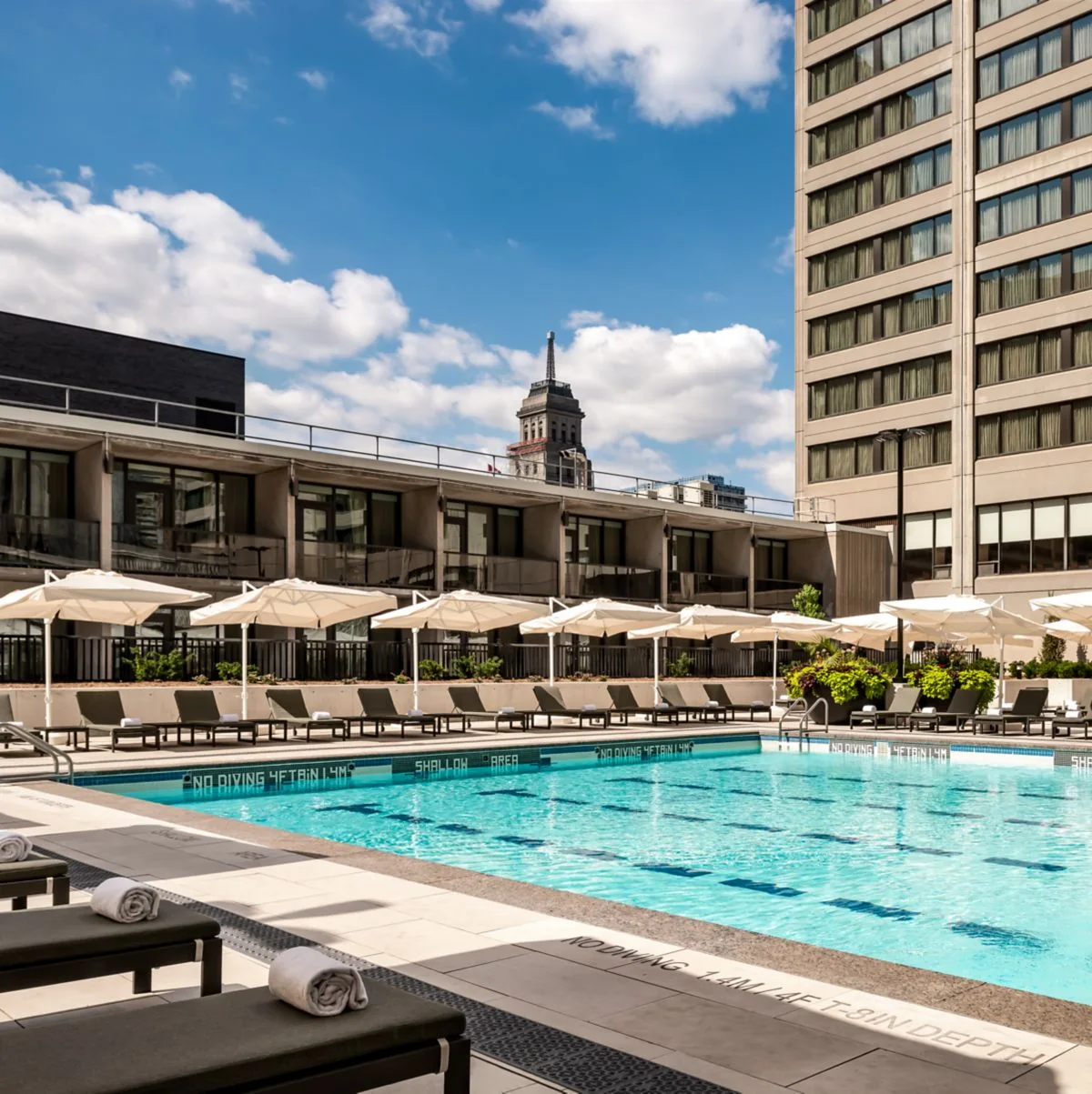 Umbrellas and loungers line Sheraton Centre Toronto’s outdoor pool