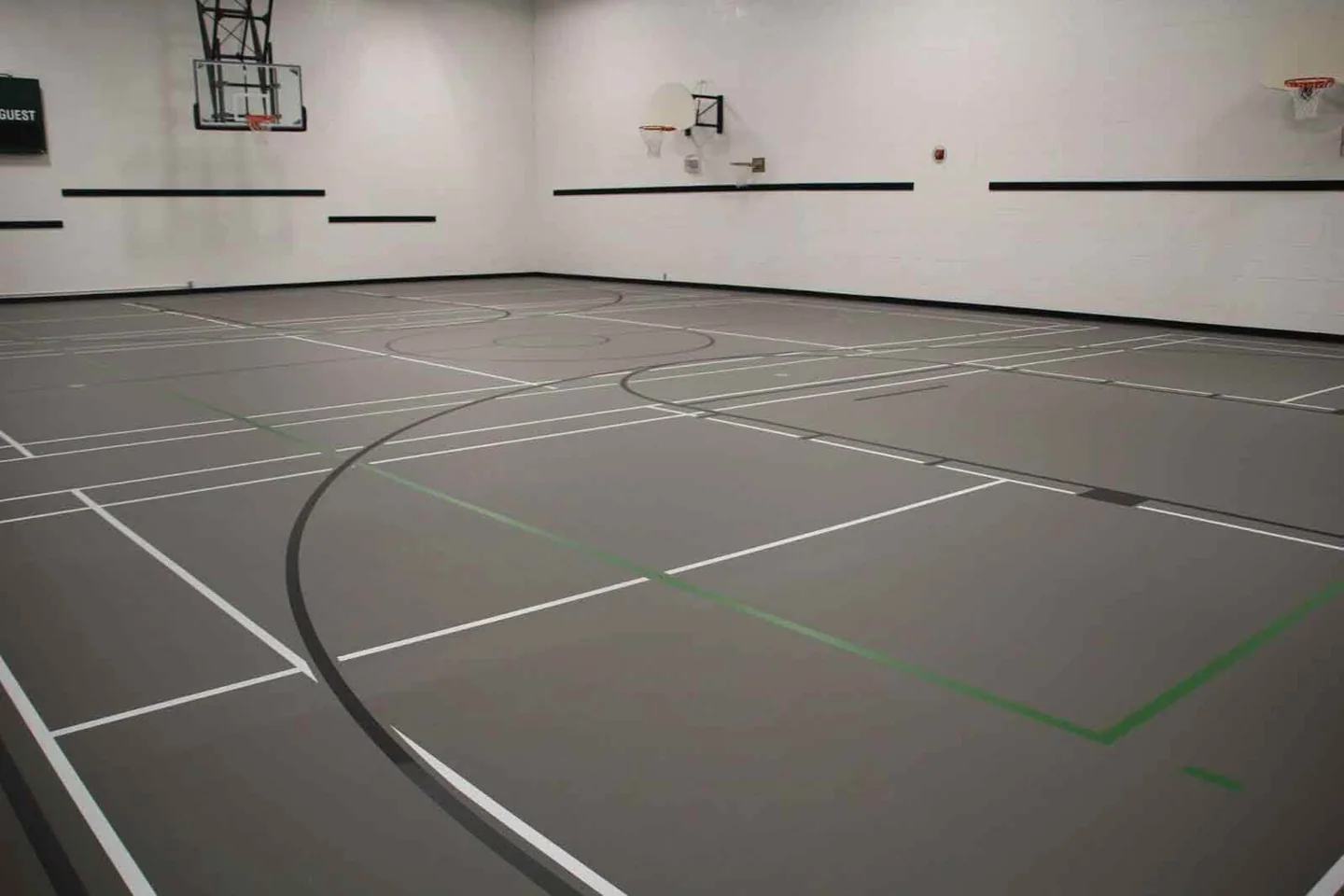 Branksome Hall gym showing several court lines, wall-mounted hoops and the distance to the wall