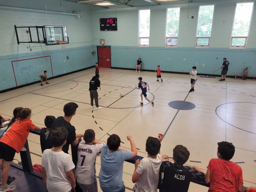Basketball players and spectators in BGC Dovercourt’s gym