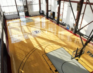Sunlight falls across a basketball court at QSLA / Ballmatics on Dupont Street