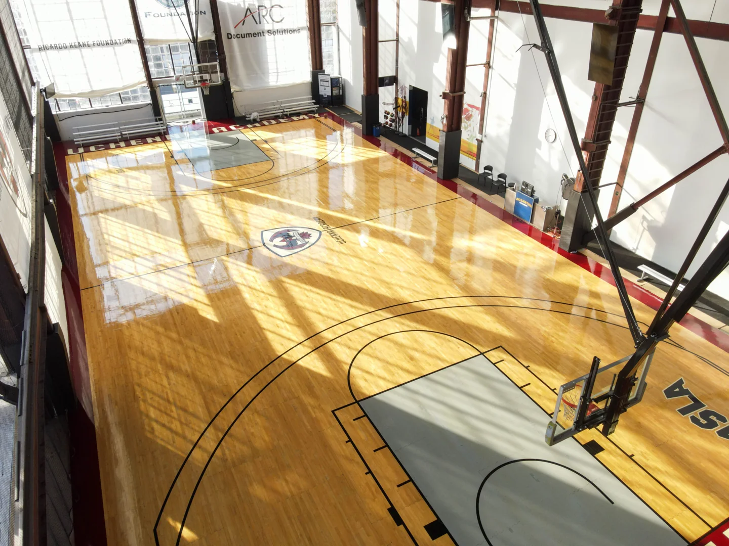 Sunlight falls across a basketball court at QSLA / Ballmatics on Dupont Street