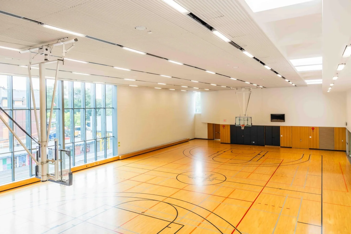 Branksome Hall gym with wooden flooring and a large wall of windows