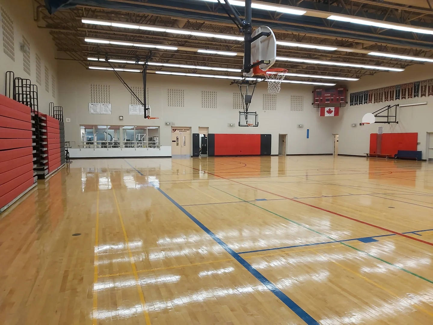 Basketball hoops and bleachers inside Monsignor Percy Johnson’s school gym