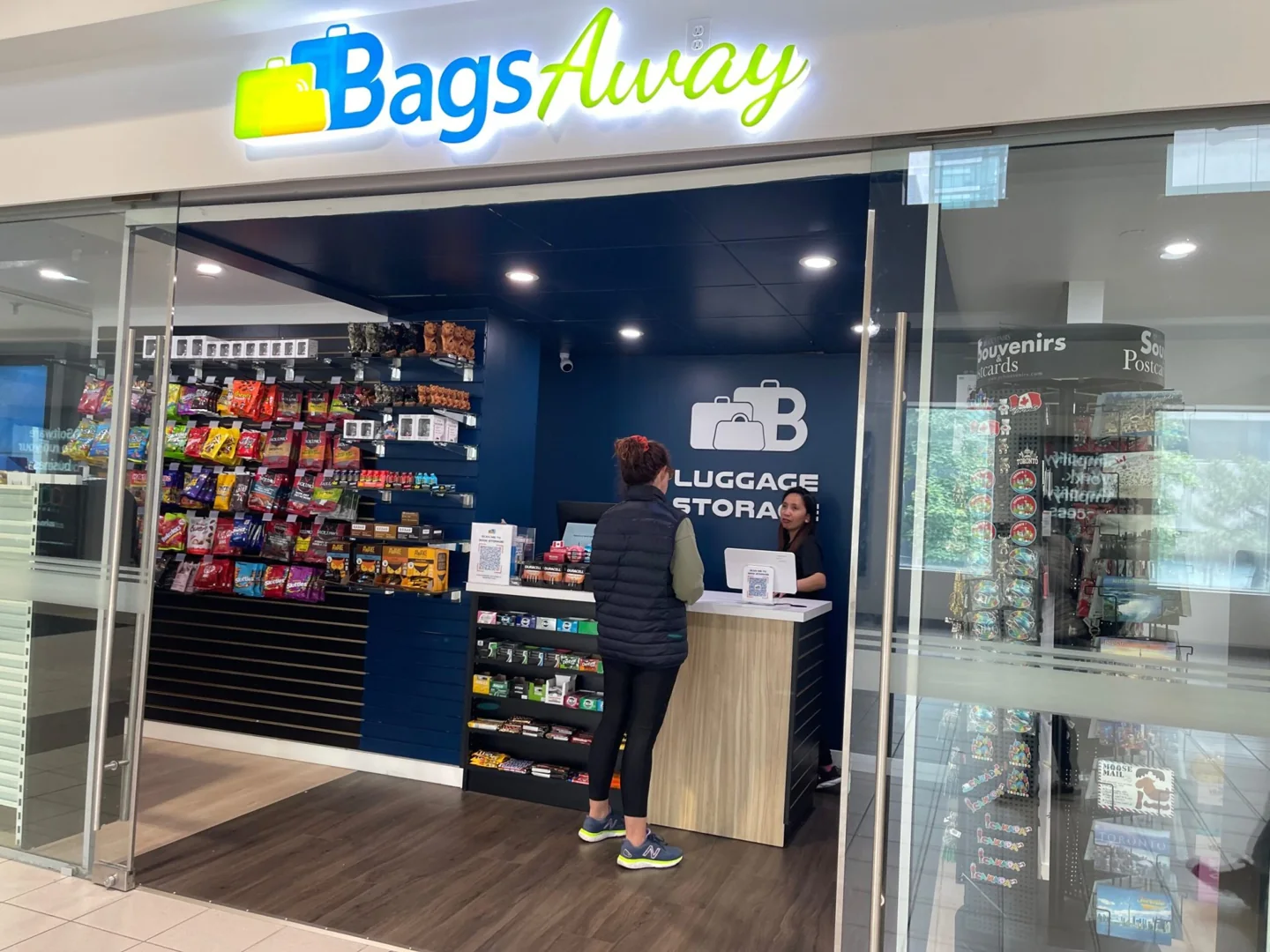 A customer stands at the counter of the BagsAway shop in Union Station’s SkyWalk