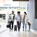Three travellers with suitcases walk towards the UP Express terminal at Union Station