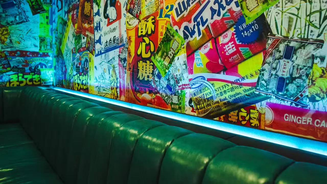 A Dasha karaoke room with banquette seating and colourful wall art