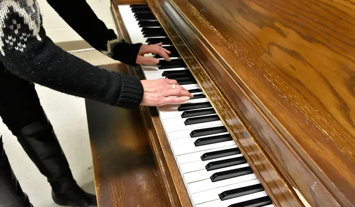 Hands practise on an upright piano