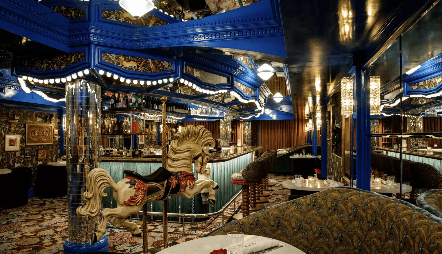 Blue draped ceiling, tables and carousel decor at Piano Piano Colborne