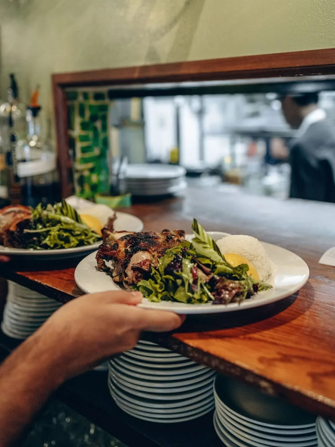 A plate of food beside Queen Mother Café’s kitchen