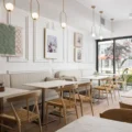 Tables, chairs and a long banquette at Tabule Midtown