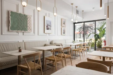 Tables, chairs and a long banquette at Tabule Midtown