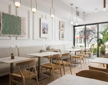 Tables, chairs and a long banquette at Tabule Midtown