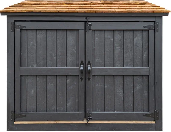 A closed grey wooden bin enclosure with a cedar roof and door handles