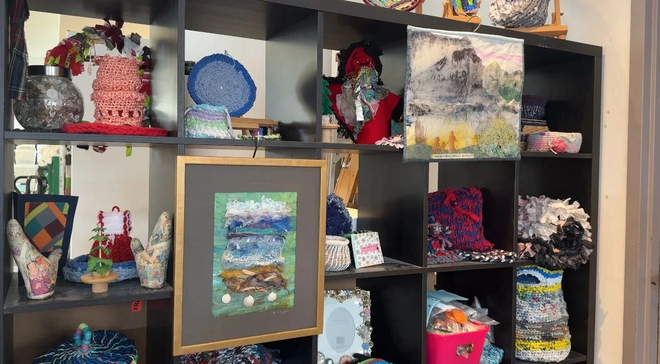 A shelf of artwork made from reused materials at Creative Reuse Toronto