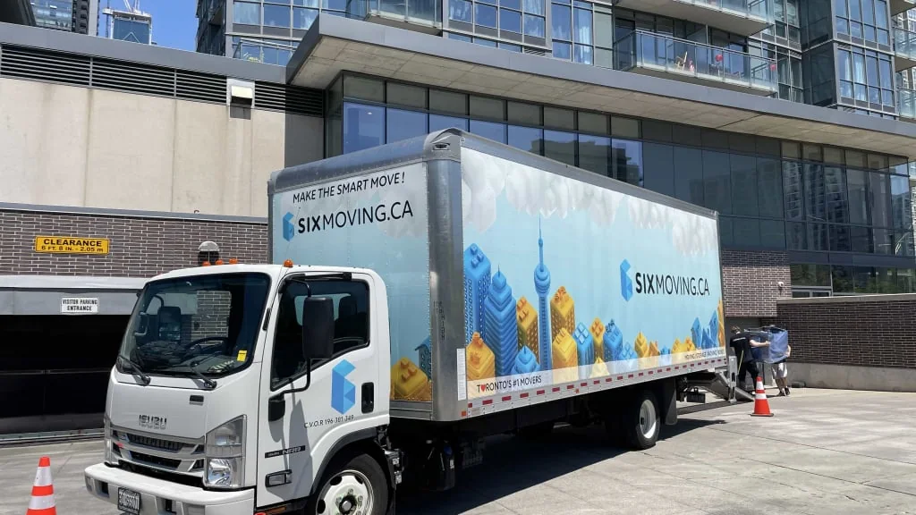 A Six Moving truck parked outside a Toronto building