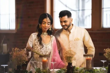 Two people wearing embroidered South Asian occasion outfits in Chandan Fashion’s photograph