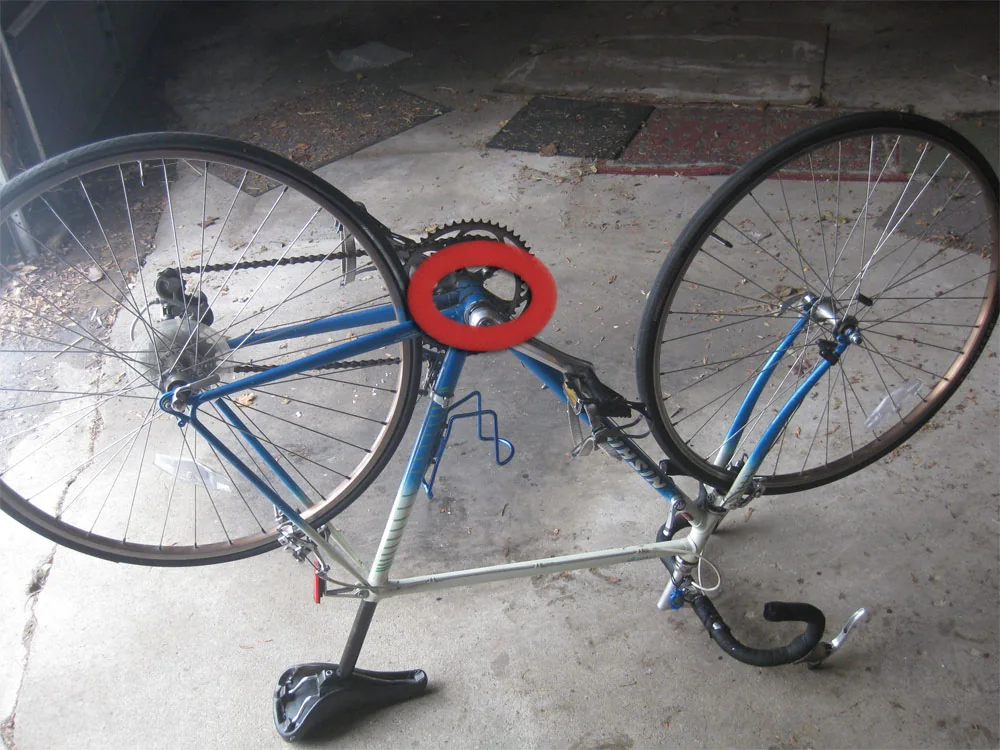 An upside-down bicycle with its bottom bracket circled as a common serial-number location
