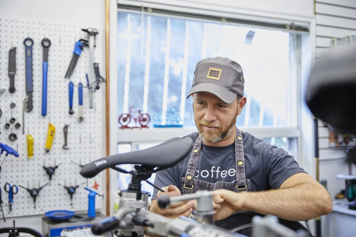 A mechanic works on a bicycle at Fix Coffee + Bikes in Toronto