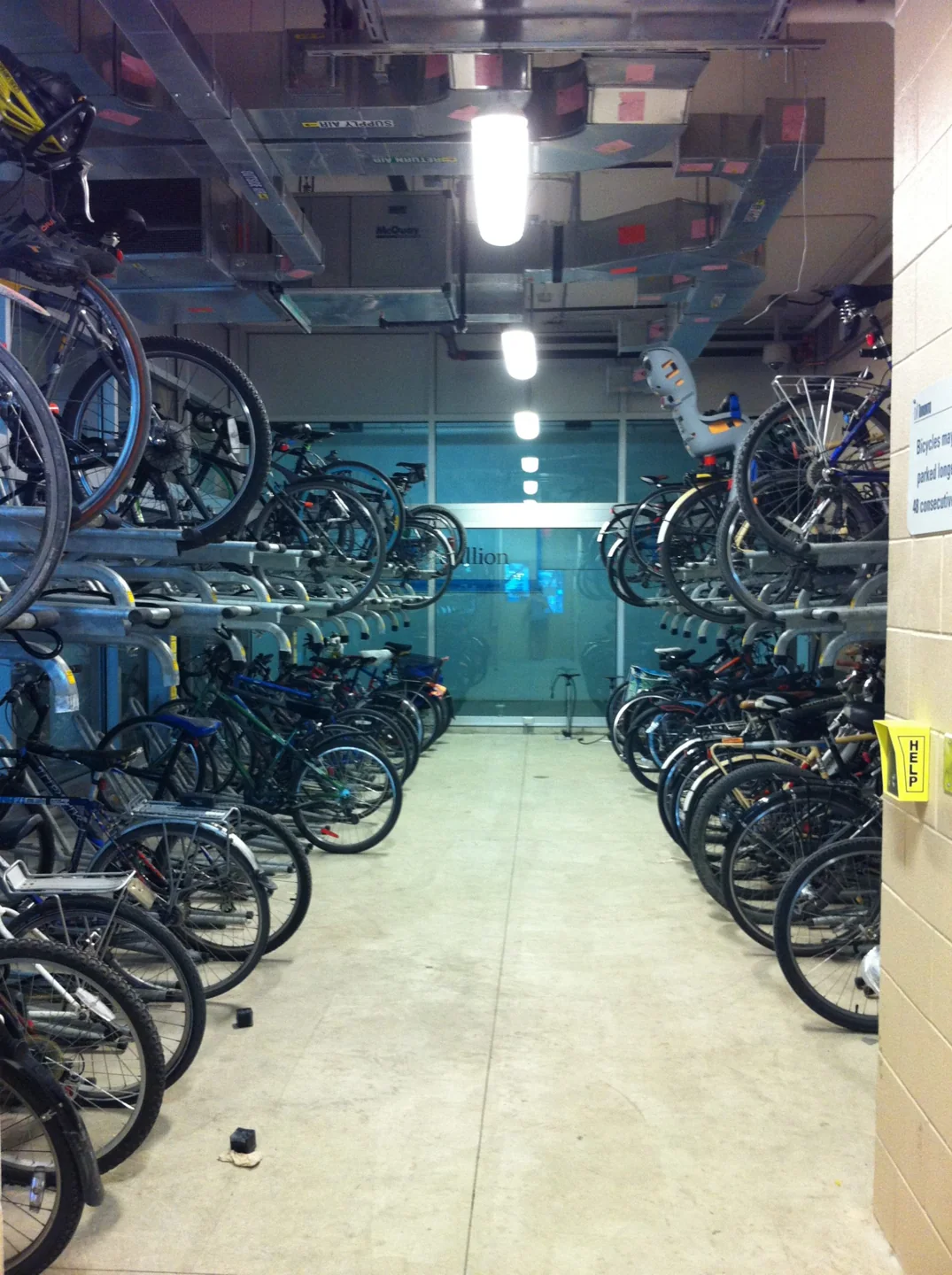 Bicycles stored in two levels of racks inside a Toronto bicycle parking station