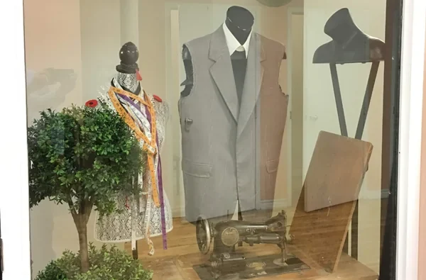 Clothing displayed behind Magic Tailor’s shop window