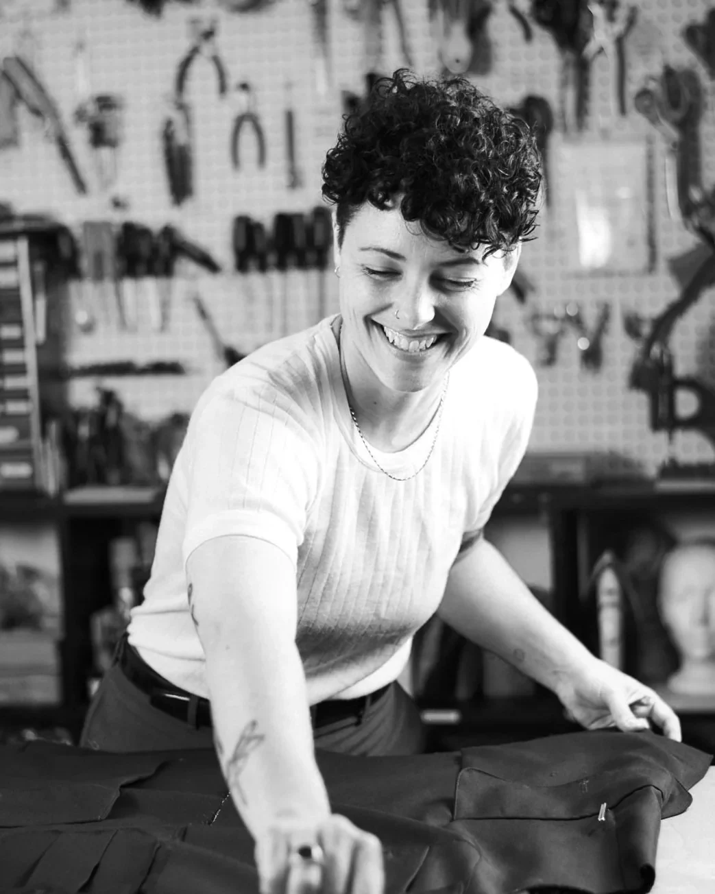 A woman working at a cutting table in Shoppe & Tailor Studios