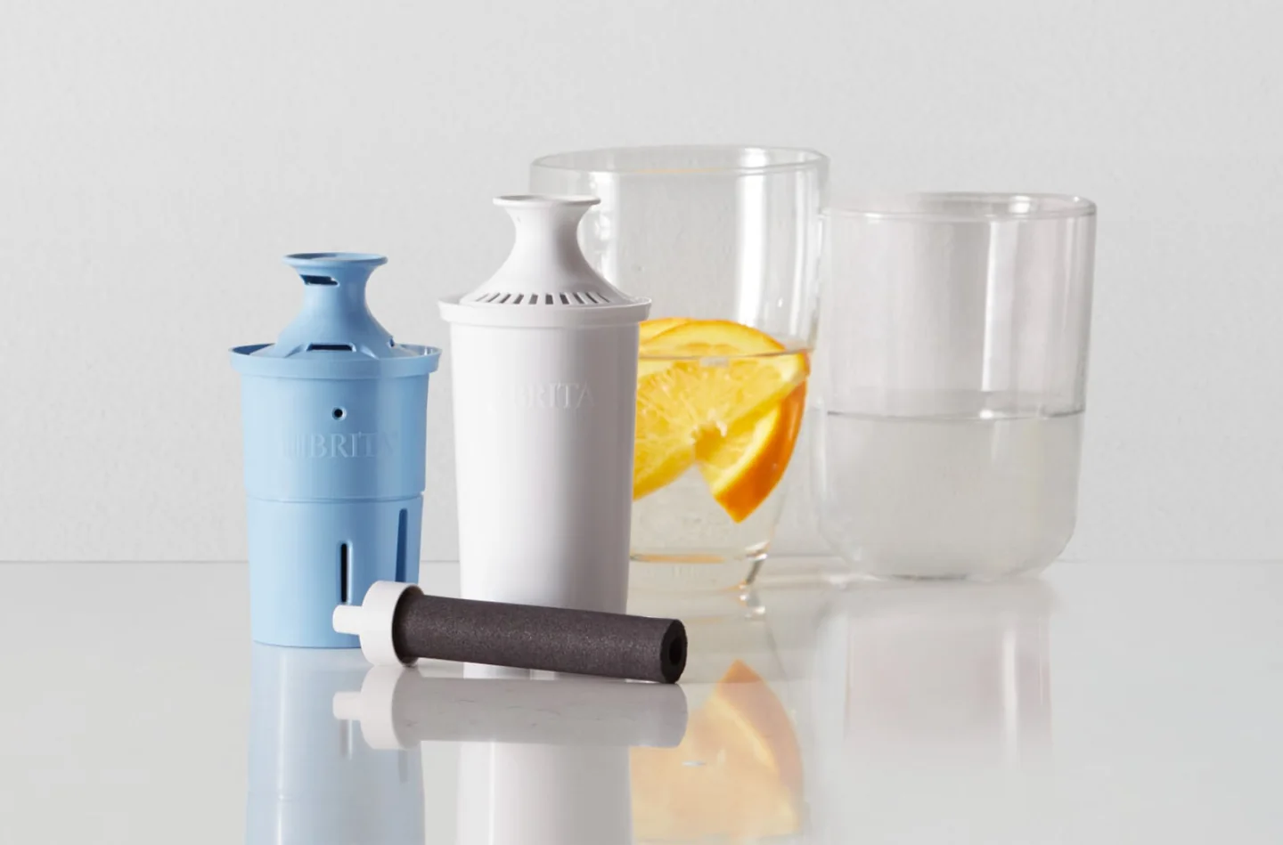 Blue and white Brita pitcher cartridges beside a black bottle cartridge