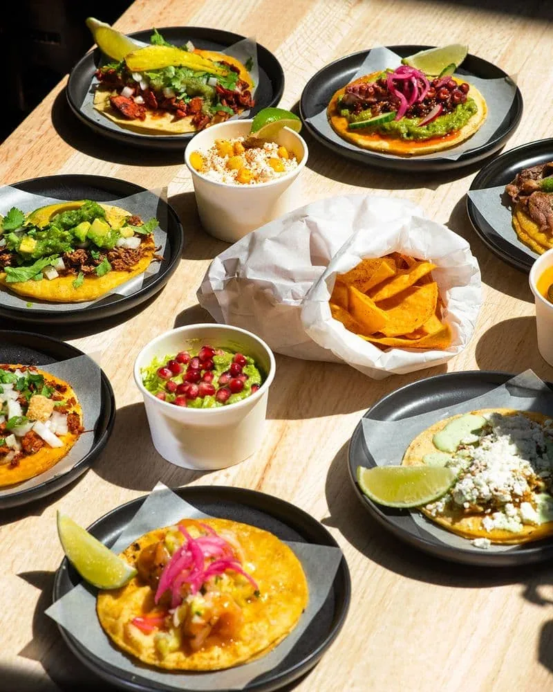 A spread of tacos and side dishes from Felix Taco Bar