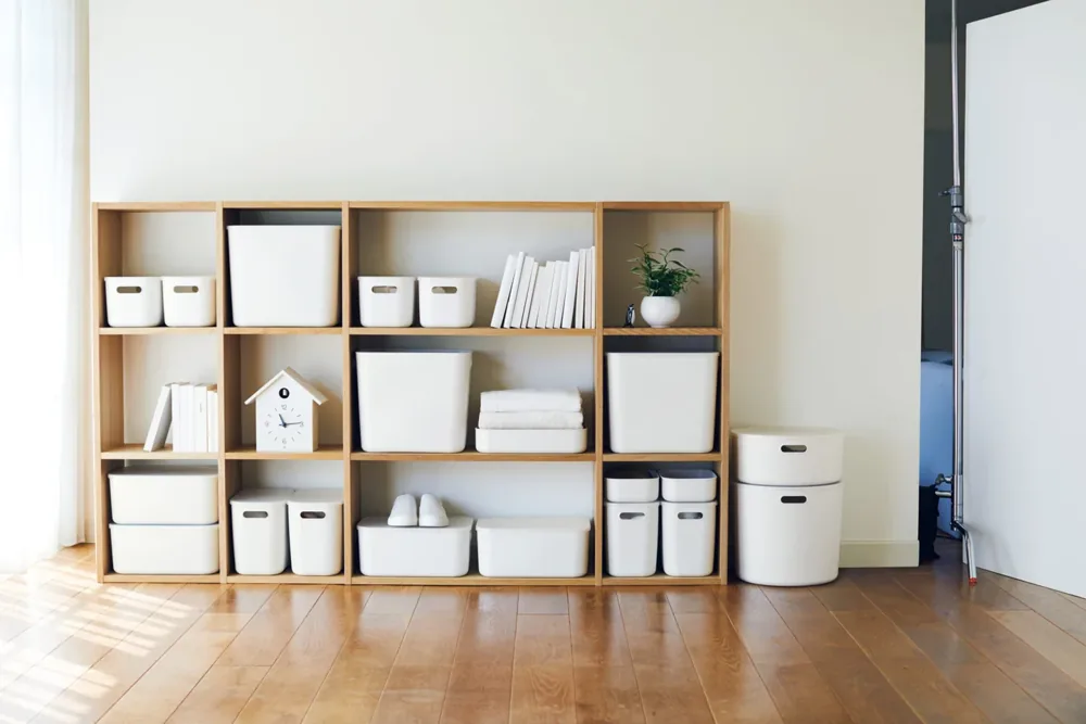 MUJI storage boxes and home goods arranged on a shelf