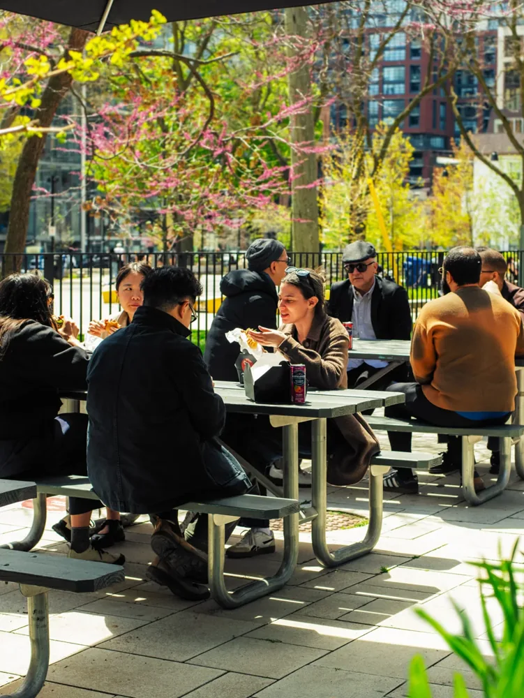People sit at outdoor tables at Waterworks